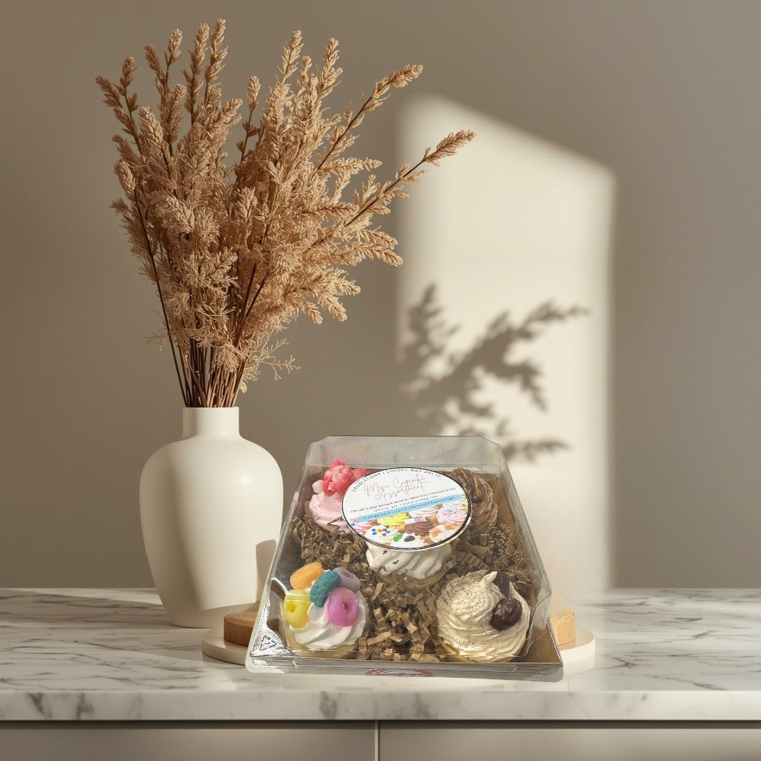 Doodlations Coffee Bar & Boutique assorted mini cupcake wax melts in a clear plastic box with 5 different scents and decorative toppings.