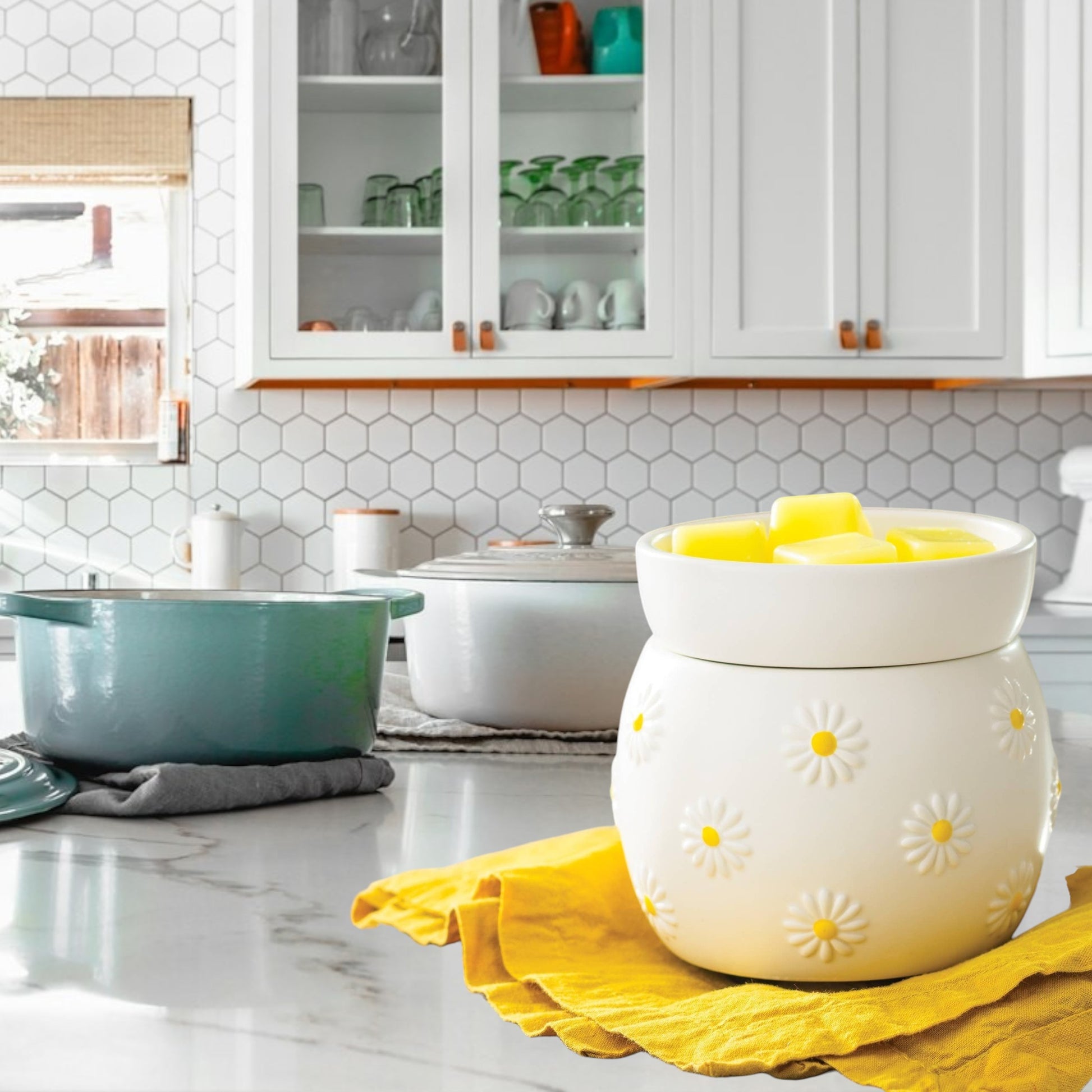 Doodlations Coffee Bar & Boutique white ceramic wax warmer with raised daisy design and yellow centers, filled with yellow wax melts.