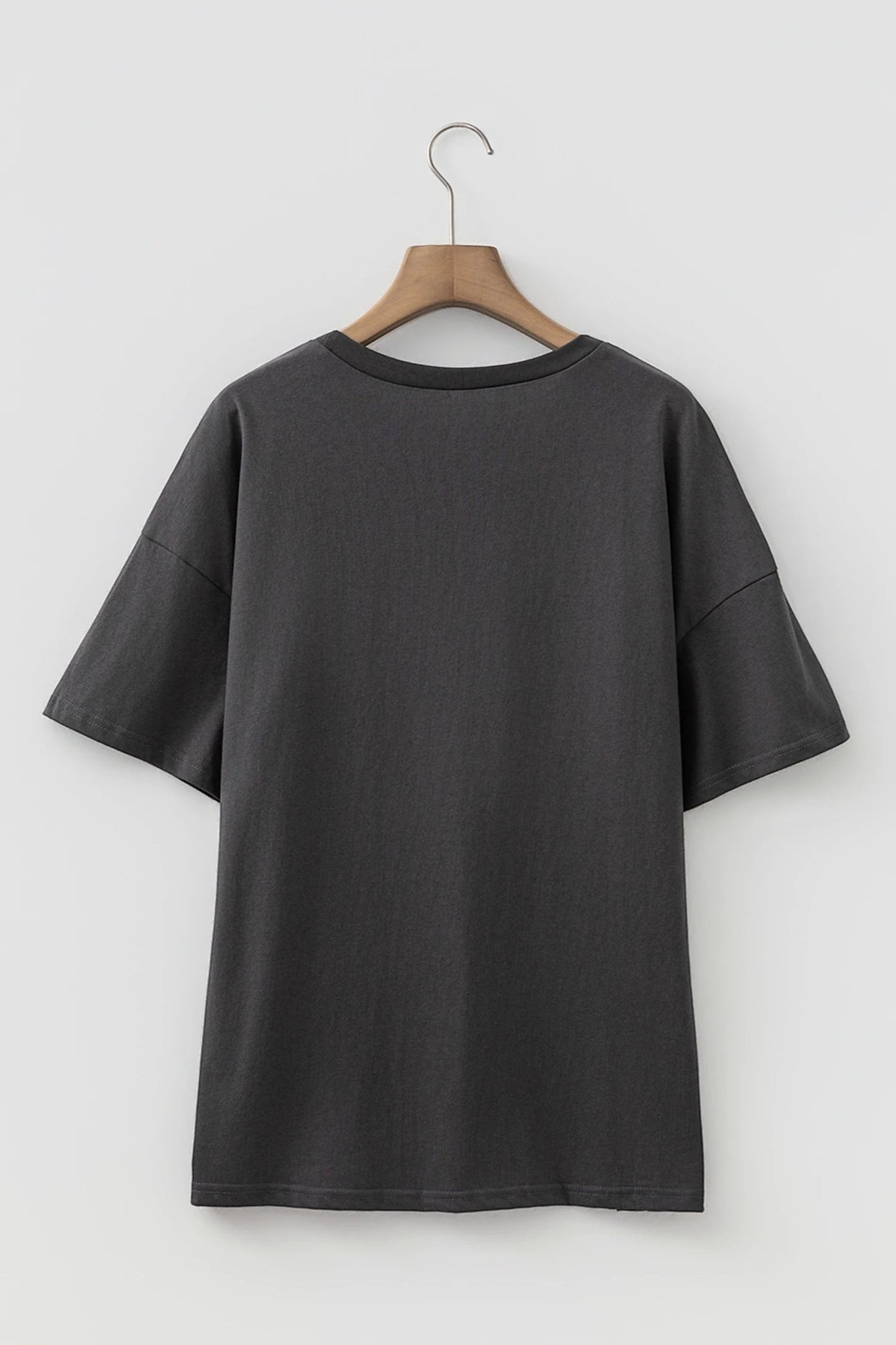 Doodlations Coffee Bar & Boutique dark grey vintage-inspired graphic t-shirt with drop shoulders on a wooden hanger