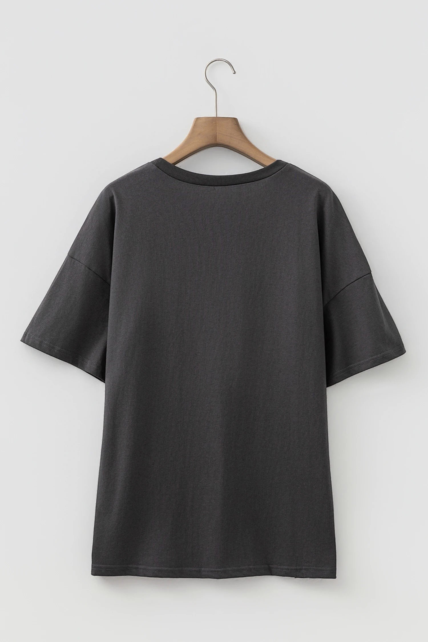Doodlations Coffee Bar & Boutique dark grey vintage-inspired graphic t-shirt with drop shoulders on a wooden hanger