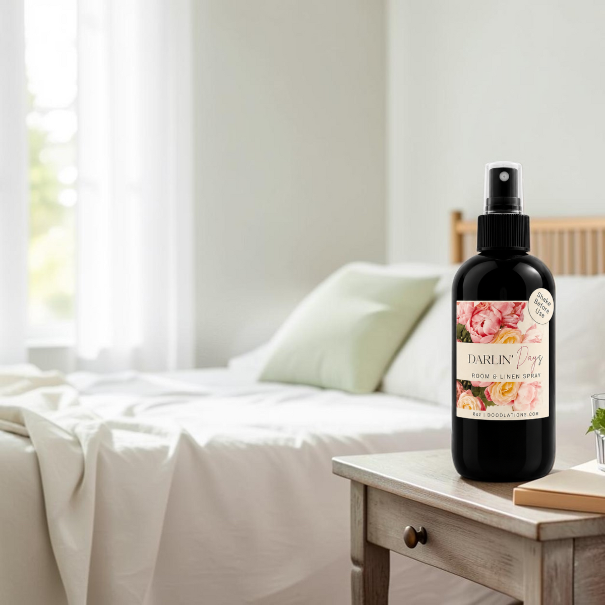 Doodlations Coffee Bar & Boutique Darlin’ Days room and linen spray bottle with floral label on a wooden bedside table.