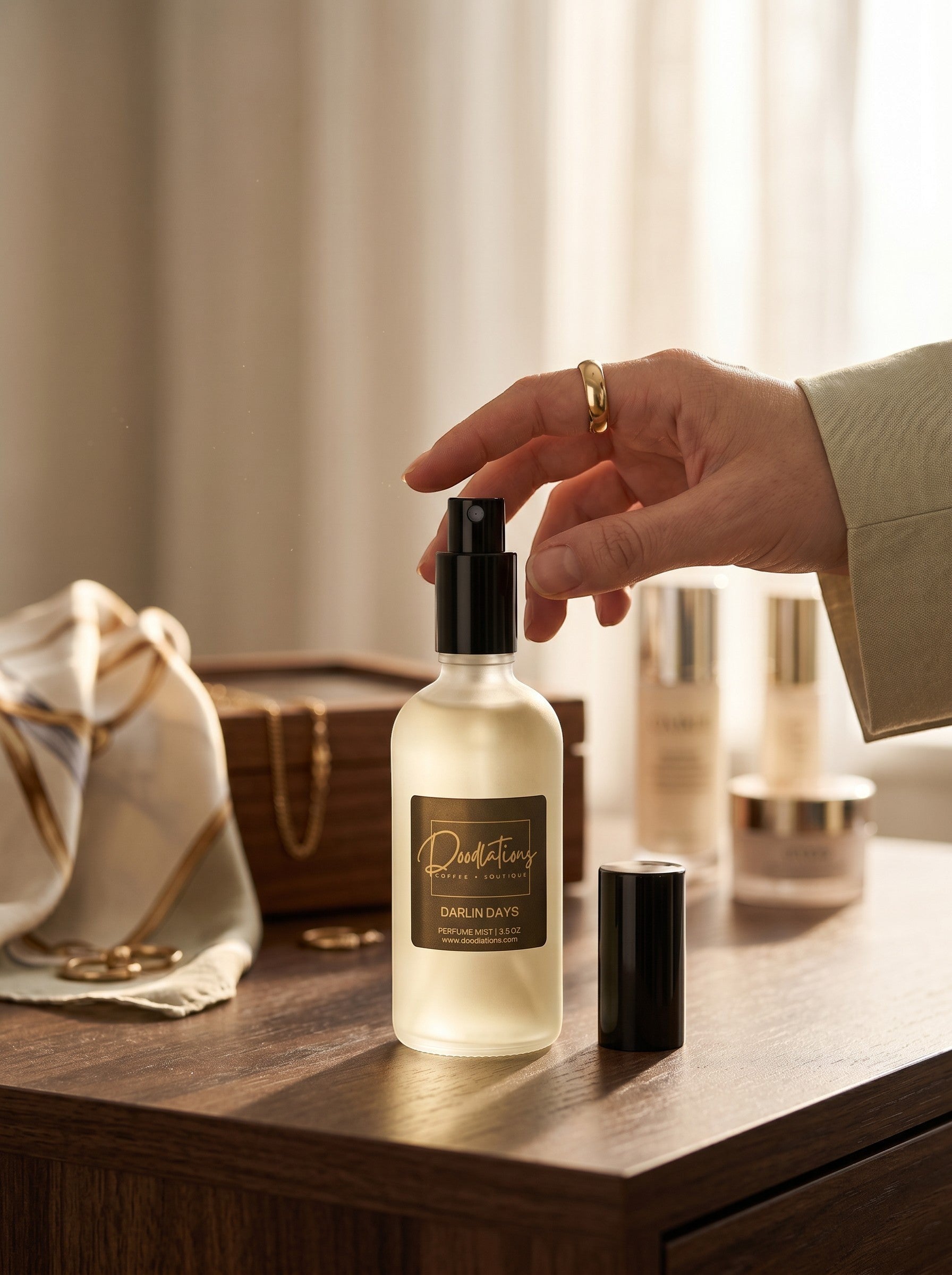 Doodlations Coffee Bar & Boutique Darlin Days fine mist perfume in a frosted glass bottle on a wooden vanity table.