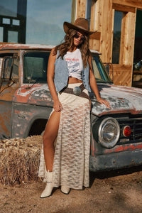 Doodlations Coffee Bar & Boutique vintage washed blue denim vest worn with a lace maxi skirt and cowboy hat