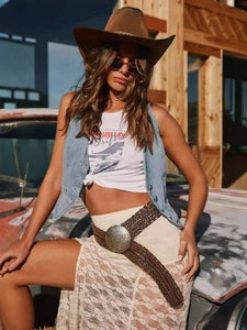 Doodlations Coffee Bar & Boutique vintage washed blue denim vest worn by a woman in a western-inspired outfit