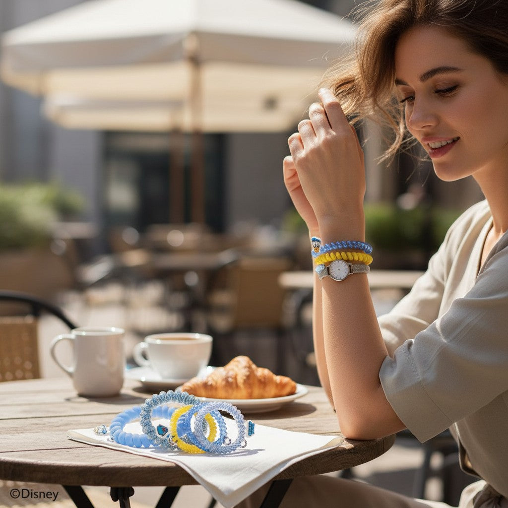 Doodlations Coffee Bar & Boutique Donald Duck spiral hair ties in blue and yellow worn as bracelets by a woman