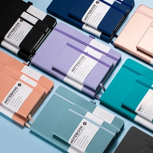 Doodlations Coffee Bar & Boutique A6 hardcover dotted journals in various vibrant colors with elastic closures.