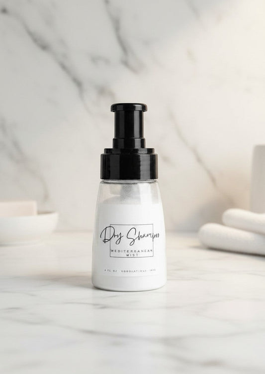 Doodlations Coffee Bar & Boutique dry powder shampoo in a clear bottle with black pump on a marble surface.