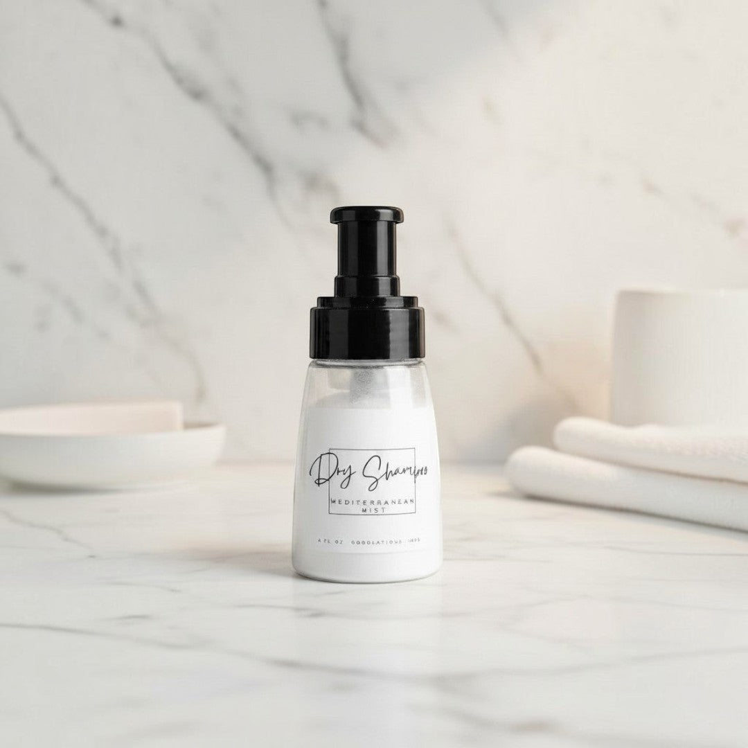 Doodlations Coffee Bar & Boutique dry powder shampoo in a clear bottle with black pump on a marble surface.