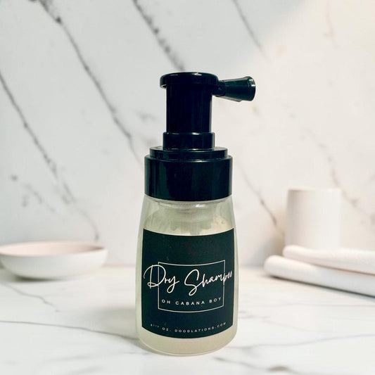 Doodlations Coffee Bar & Boutique dry powder shampoo bottle with black pump dispenser on a marble surface