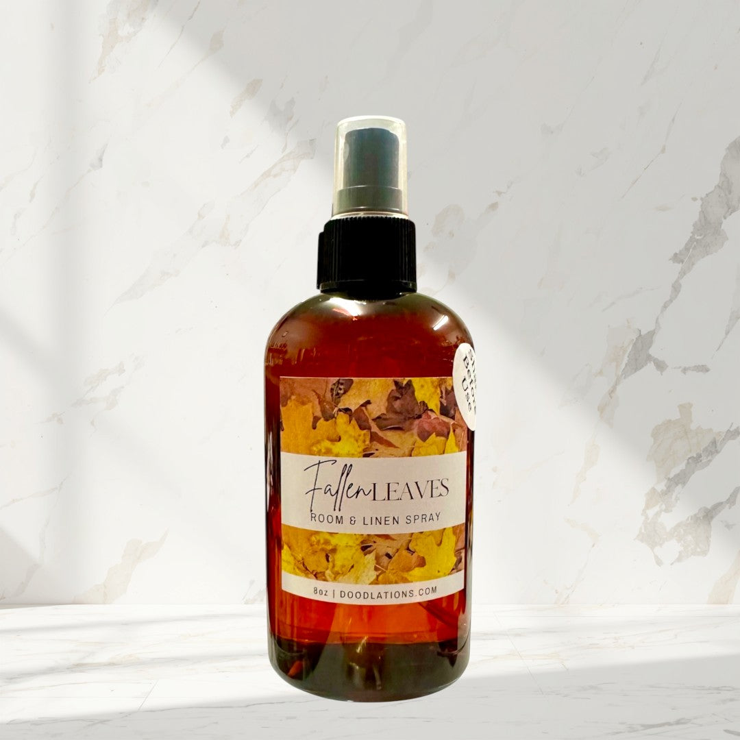 Doodlations Coffee Bar & Boutique Fallen Leaves room and linen spray in amber glass bottle with autumn leaf label.