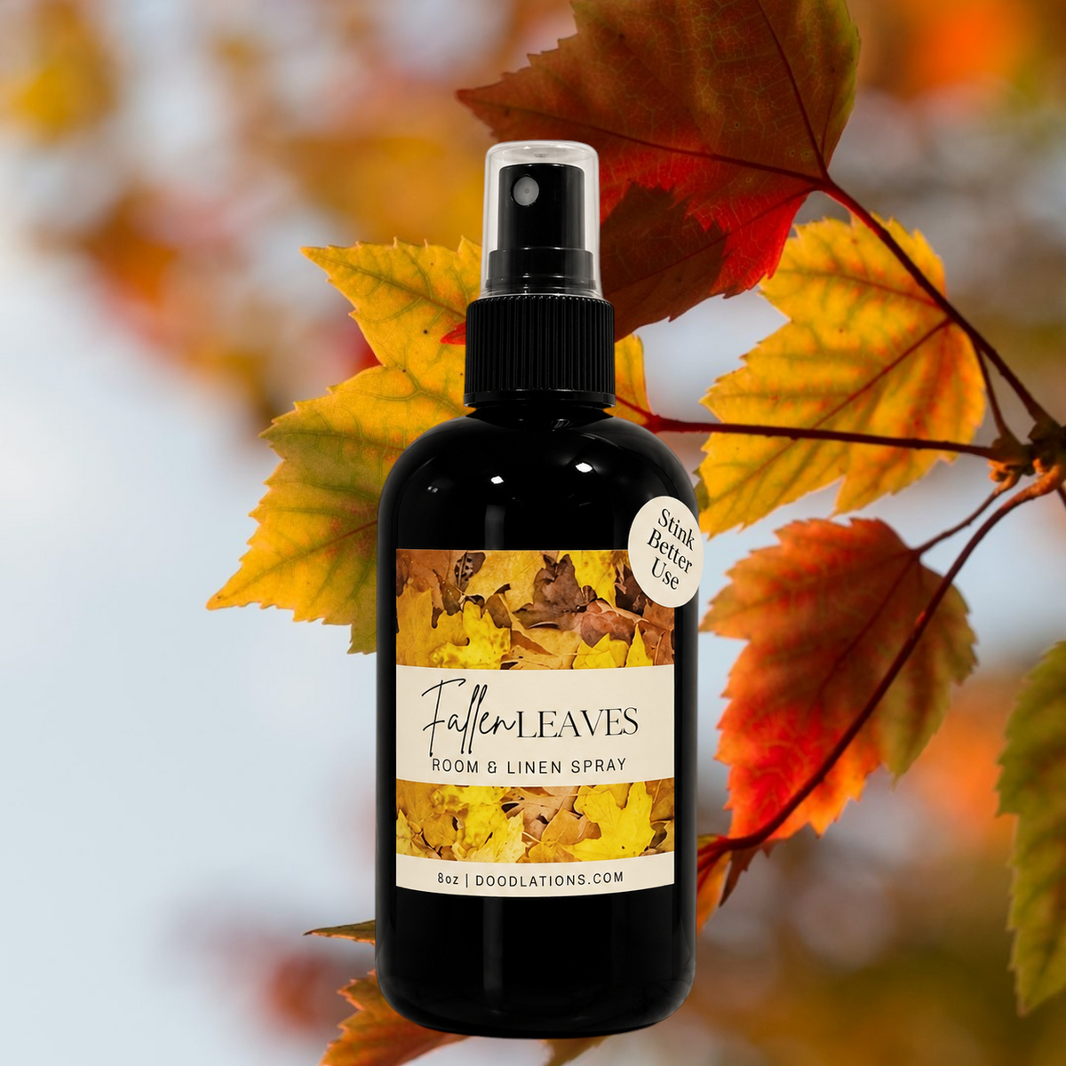 Doodlations Coffee Bar & Boutique Fallen Leaves room and linen spray in a black bottle with autumn leaf label design.