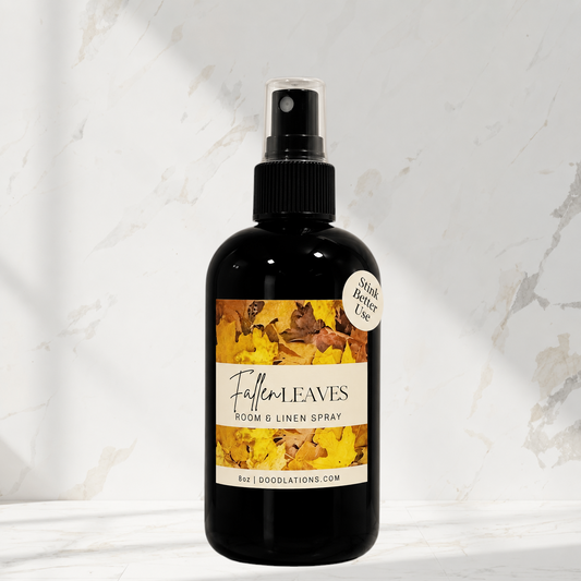 Doodlations Coffee Bar & Boutique Fallen Leaves room and linen spray in a black bottle with autumn leaf label design.