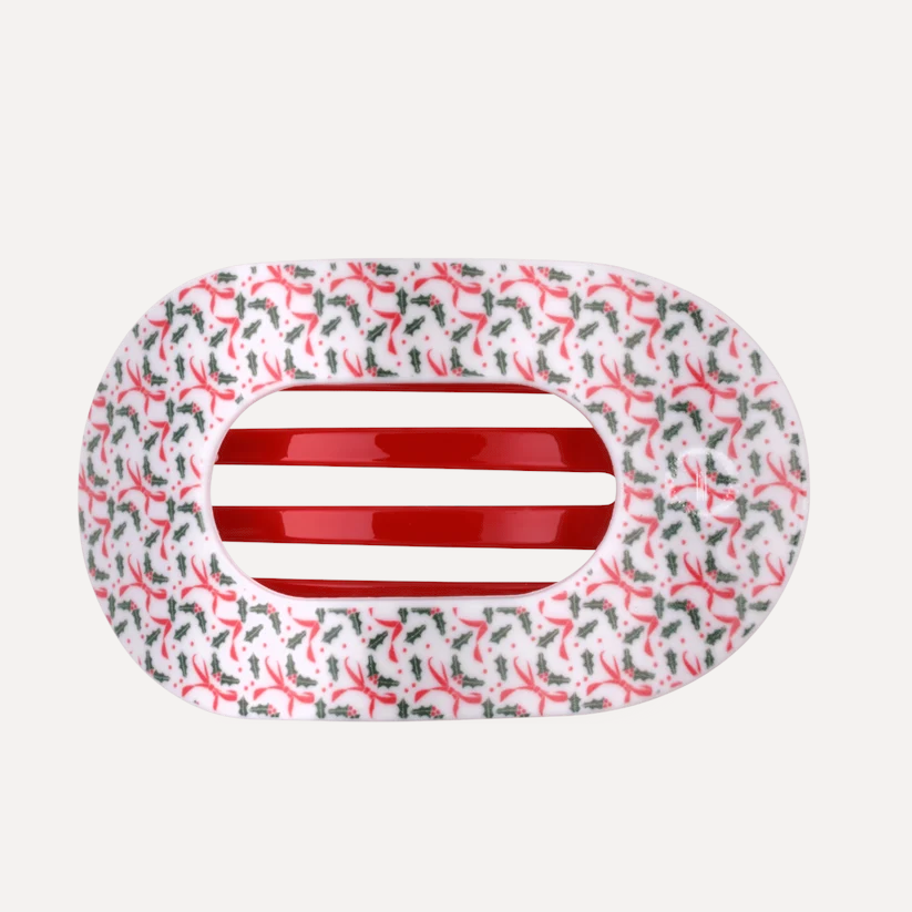Doodlations Coffee Bar & Boutique Teleties flat round hair clip with a festive red ribbon and holly leaf pattern.