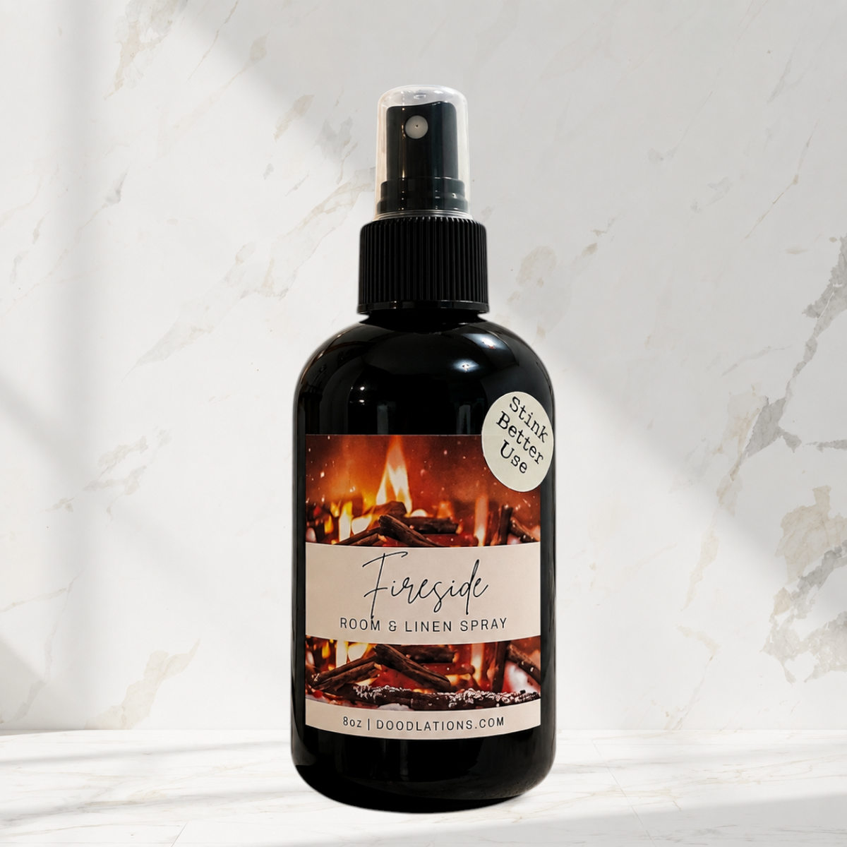 Doodlations Coffee Bar & Boutique Fireside room and linen spray in a black bottle with a fireplace label.