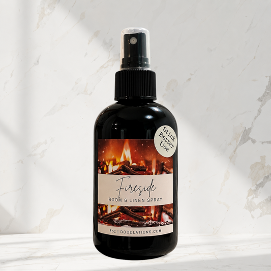 Doodlations Coffee Bar & Boutique Fireside room and linen spray in a black bottle with a fireplace label.