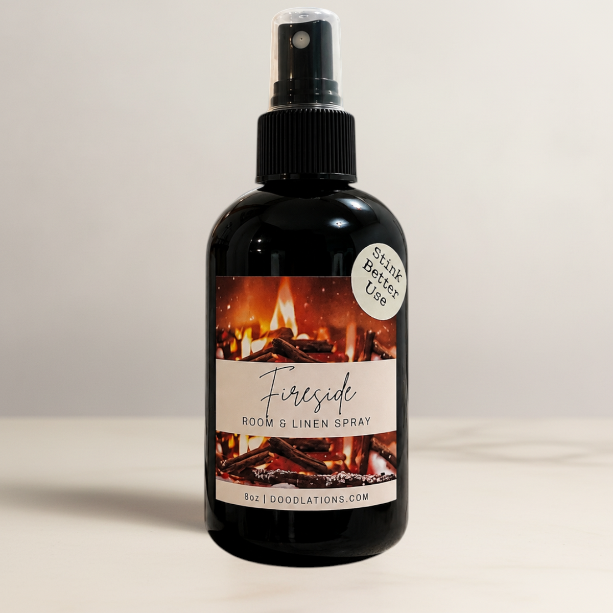 Doodlations Coffee Bar & Boutique Fireside room and linen spray in a black bottle with a fireplace label.