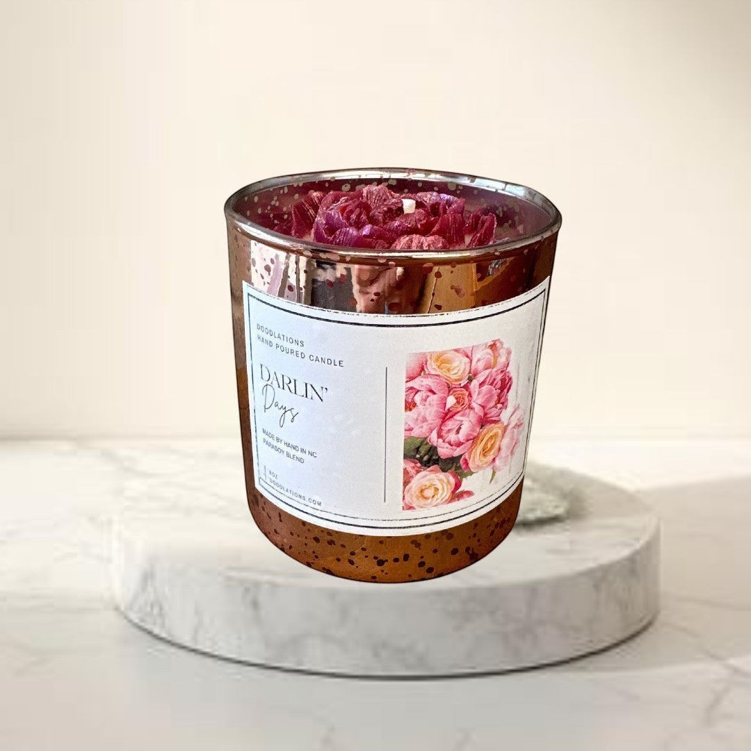Doodlations Darlin' Days floral candle in a rose gold mercury glass jar with pink and cream rose topping.