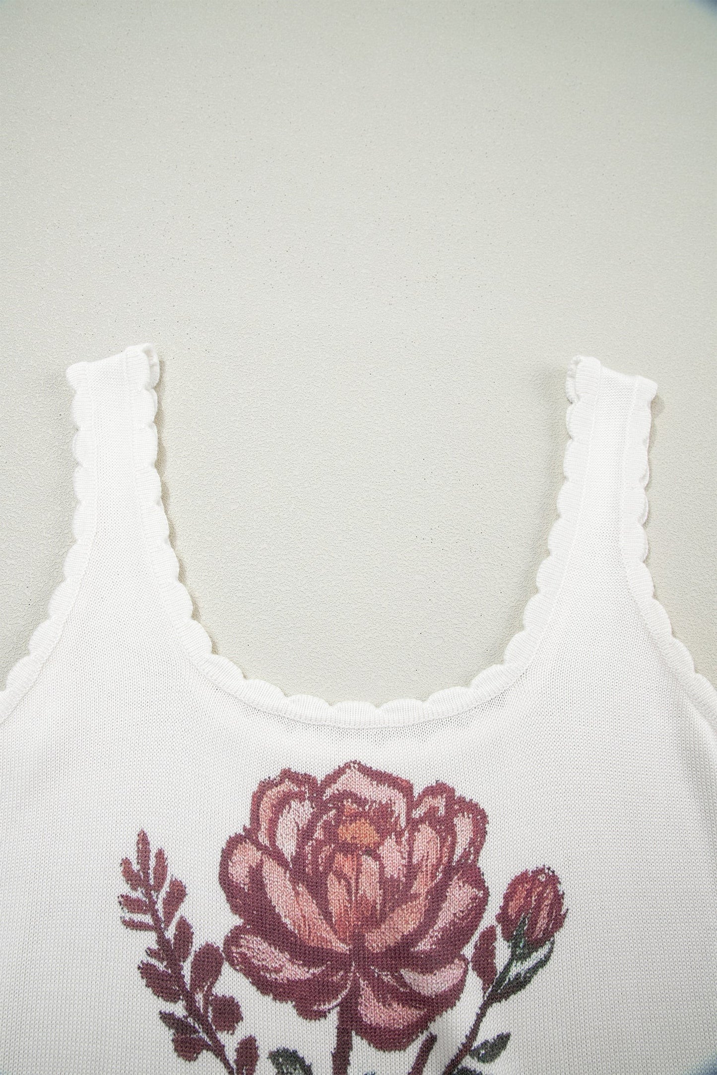 Doodlations Coffee Bar & Boutique white knit tank top with a pink floral graphic and delicate scalloped trim neckline