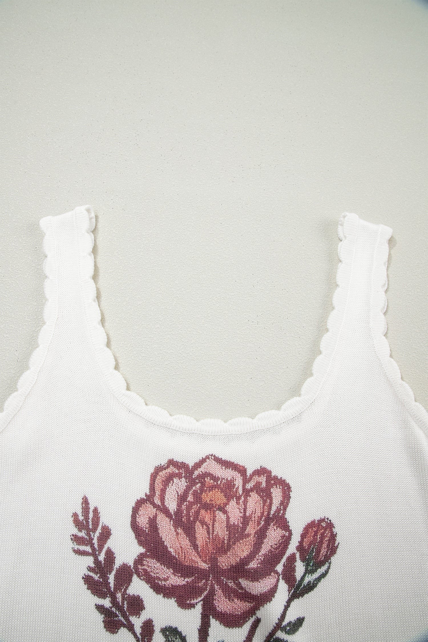 Doodlations Coffee Bar & Boutique white knit tank top with a pink floral graphic and delicate scalloped trim neckline