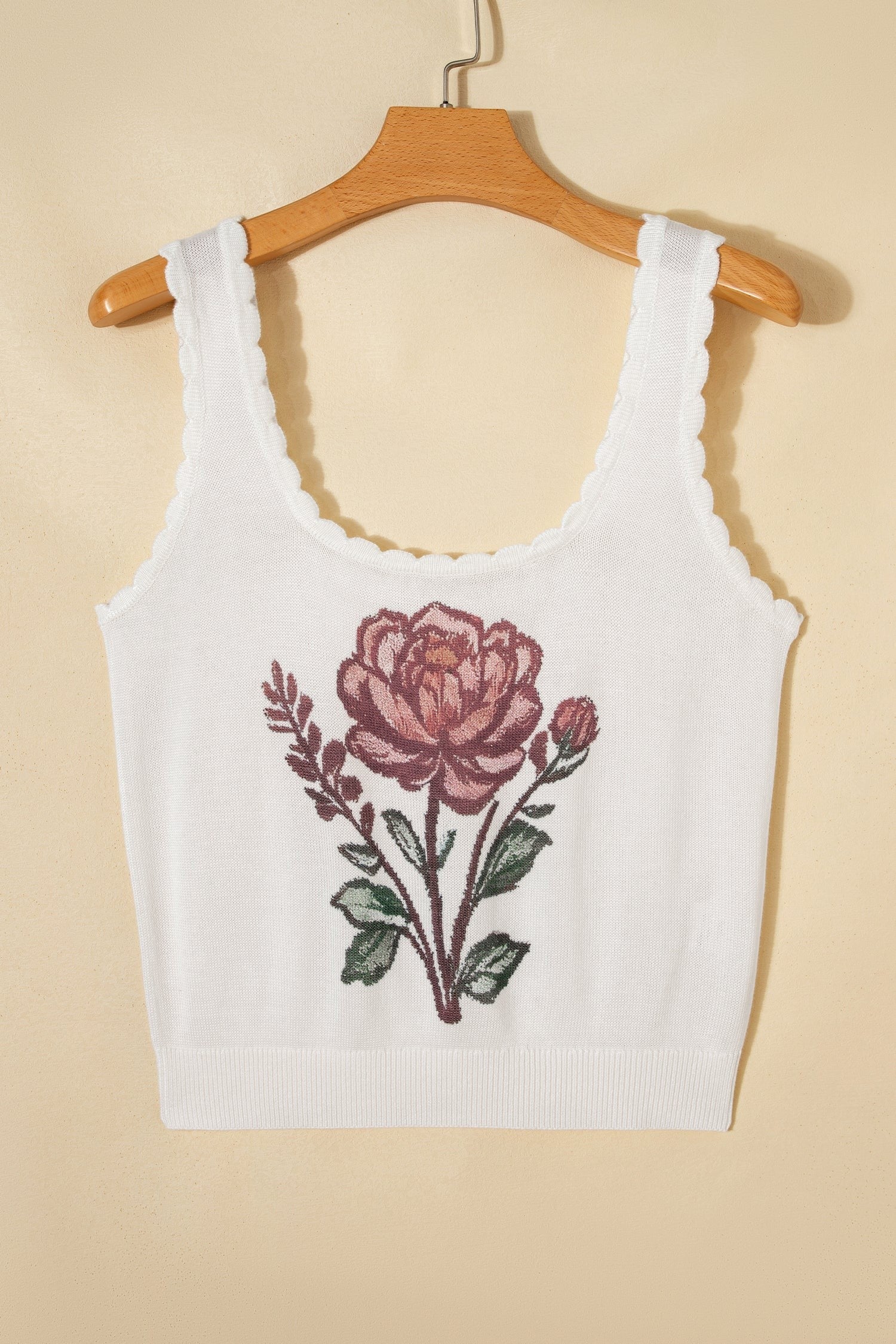 Doodlations Coffee Bar & Boutique white knit tank top with a pink floral graphic and delicate scalloped trim edges.