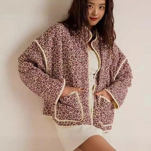 Doodlations Coffee Bar & Boutique floral quilted zip-up jacket with cream piping and patch pockets on a model