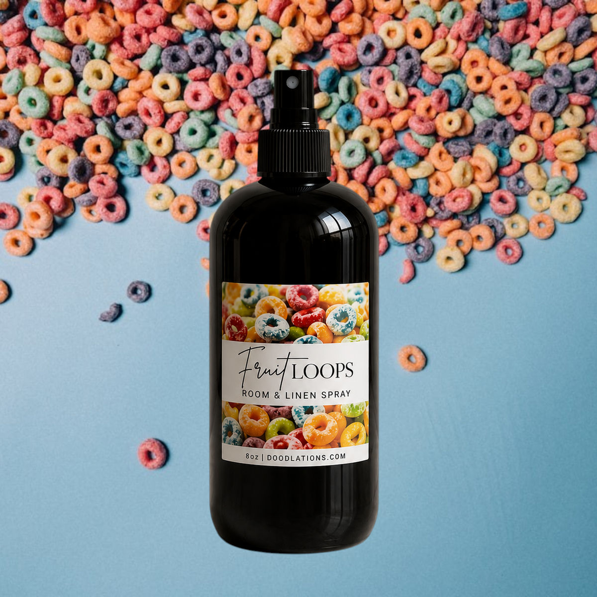 Doodlations Coffee Bar & Boutique Fruit Loop room and linen spray in a black bottle on a blue background with cereal.