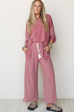 Doodlations Coffee Bar & Boutique fuchsia raw seam long sleeve top and striped wide leg pants 2-piece set on a model