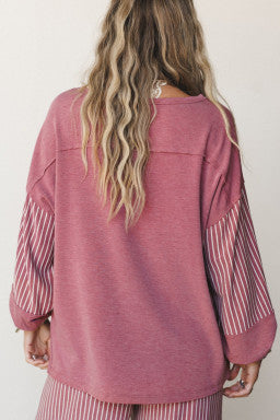 Doodlations Coffee Bar & Boutique fuchsia long sleeve top with raw seams and striped sleeves, back view