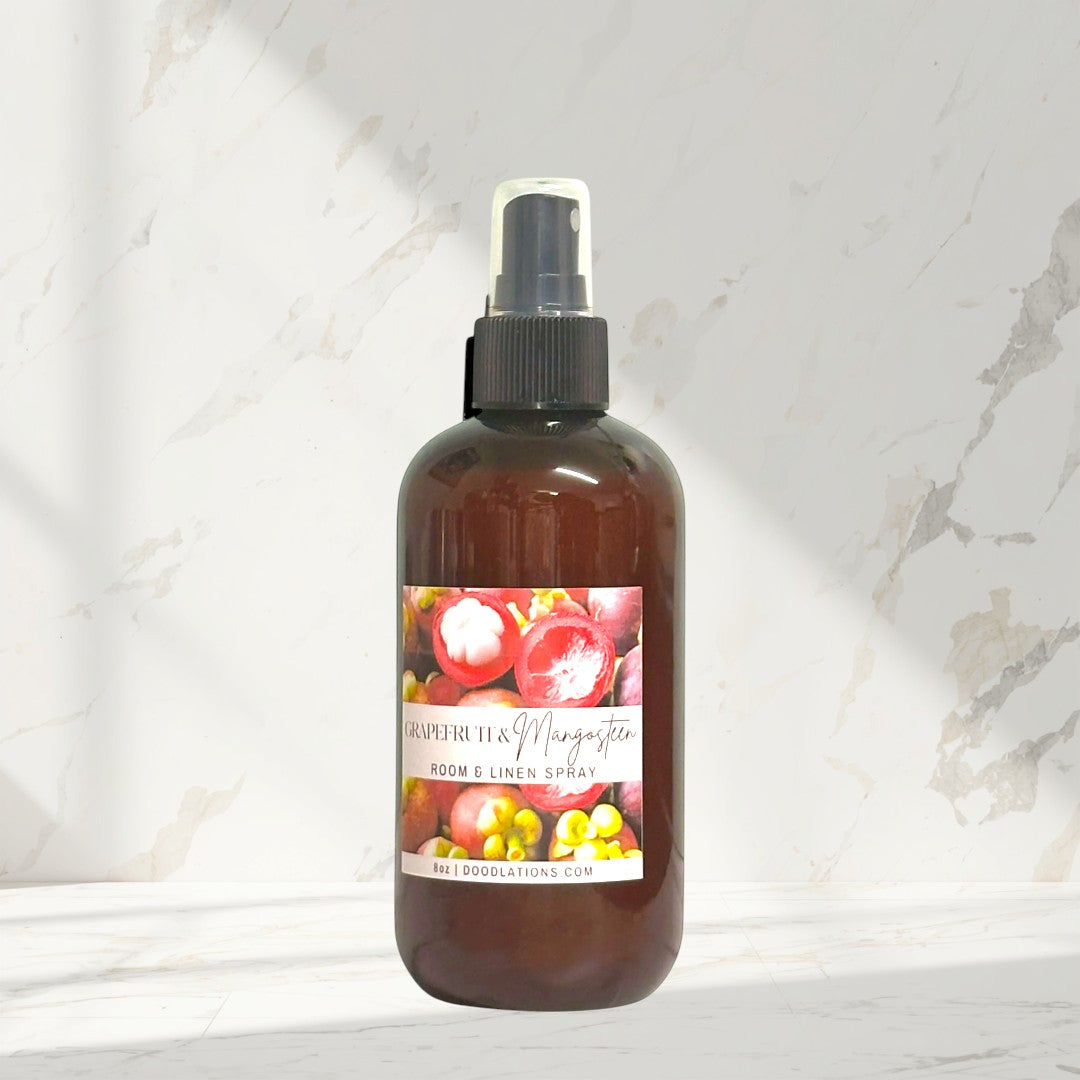 Doodlations Coffee Bar & Boutique Grapefruit Mangosteen Room & Linen Spray bottle with label showing fruit.