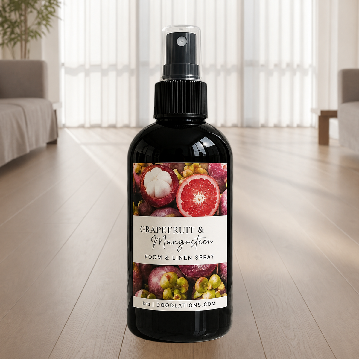 Doodlations Coffee Bar & Boutique Grapefruit & Mangosteen room and linen spray in a black bottle on a wooden floor.