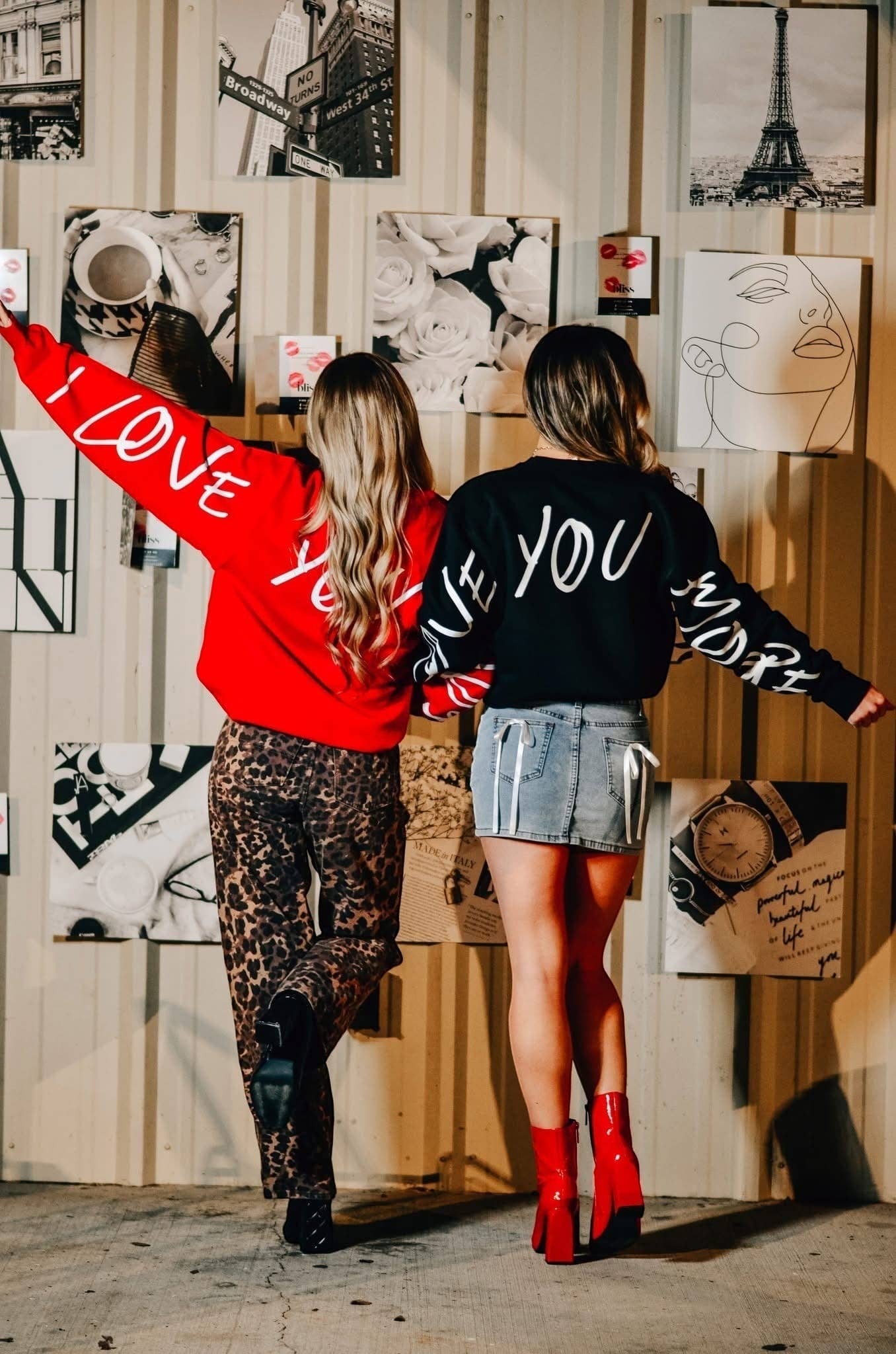 Doodlations Coffee Bar & Boutique graphic sweatshirts in red and black with white script on sleeves and back.