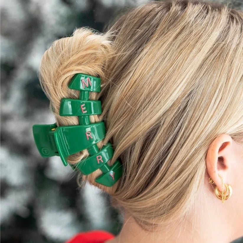 Doodlations Coffee Bar & Boutique green Teletie Merry hair claw clip holding blonde hair in a bun