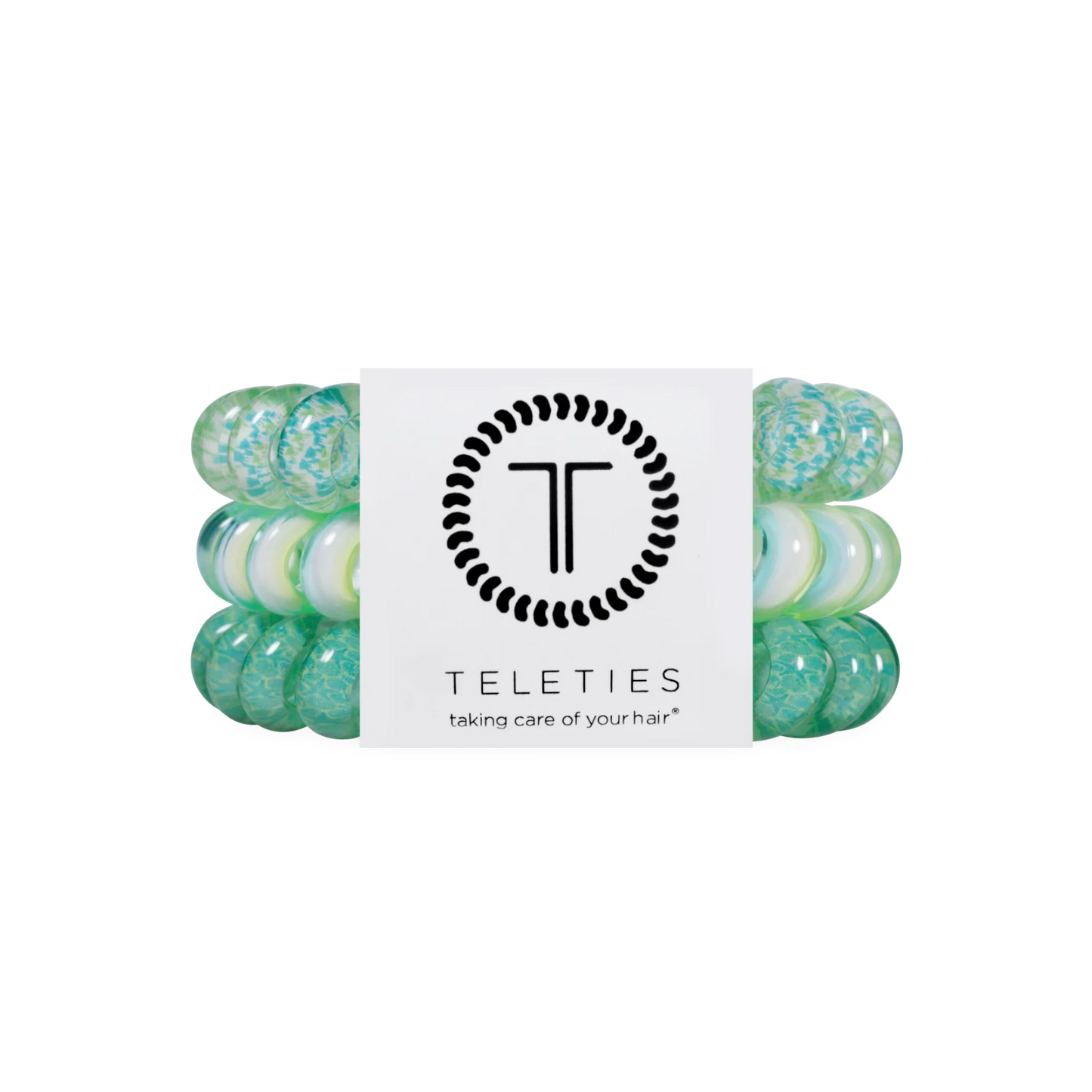 Doodlations Coffee Bar & Boutique By the Sea Shore spiral hair ties in shades of green and white on display card.