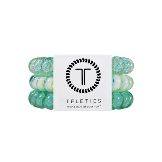 Doodlations Coffee Bar & Boutique By the Sea Shore spiral hair ties in shades of green and white on display card.