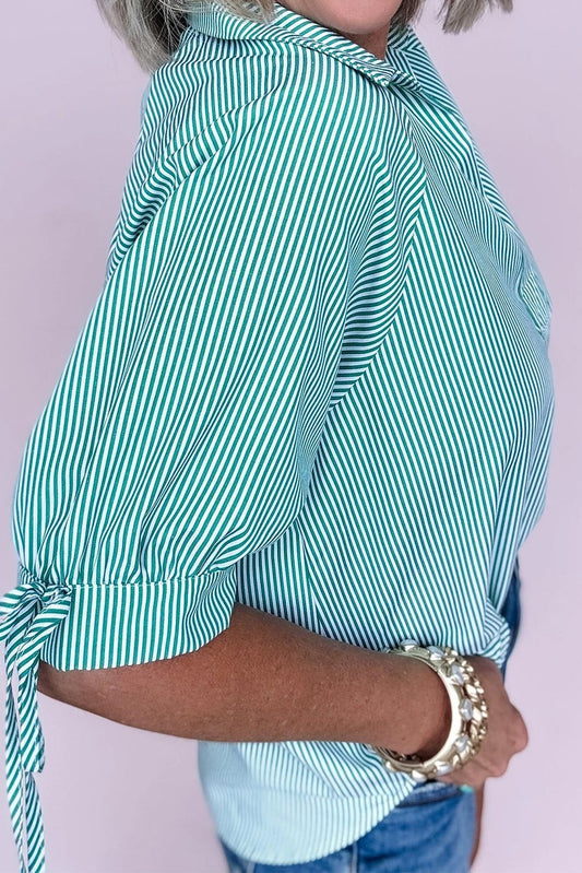 Doodlations Coffee Bar & Boutique green and white striped puff sleeve button-up shirt with tie cuffs.