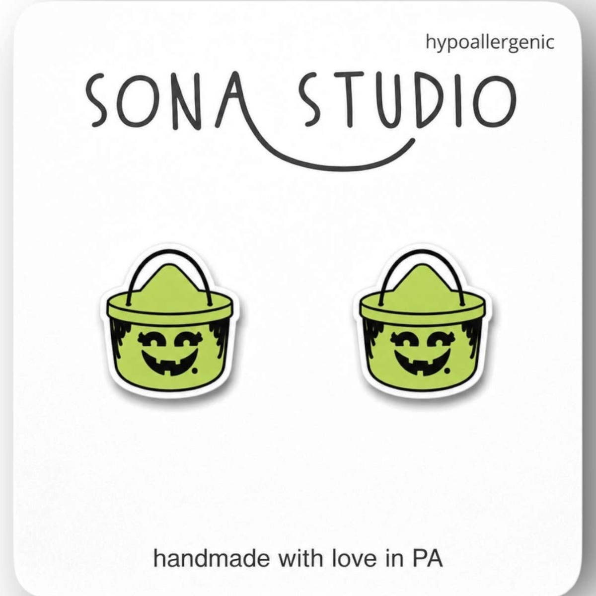 Doodlations Coffee Bar & Boutique handmade green acrylic Halloween witch bucket stud earrings on display card