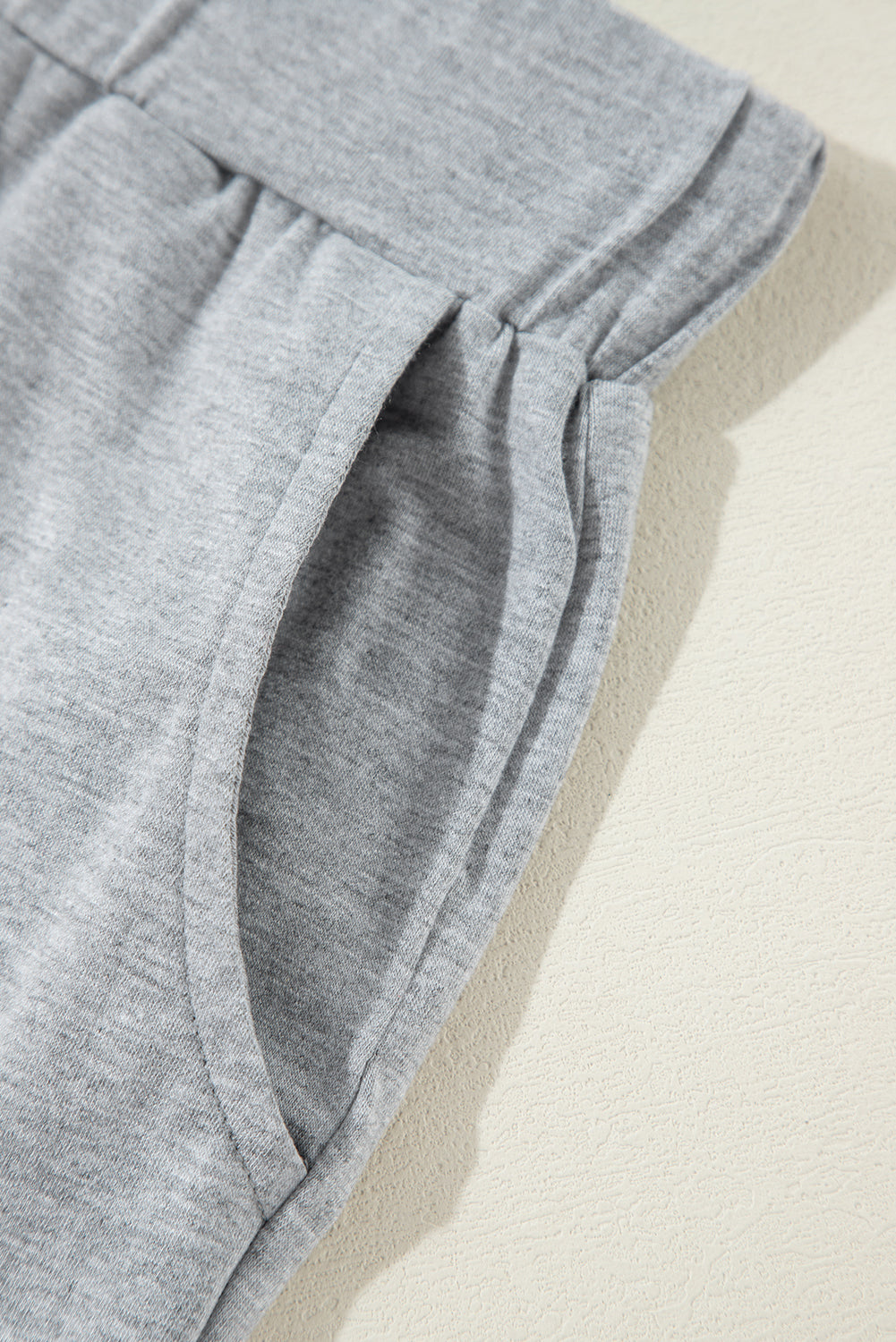 Close-up of the grey fabric side pocket on the Doodlations Coffee Bar & Boutique lounge set pants