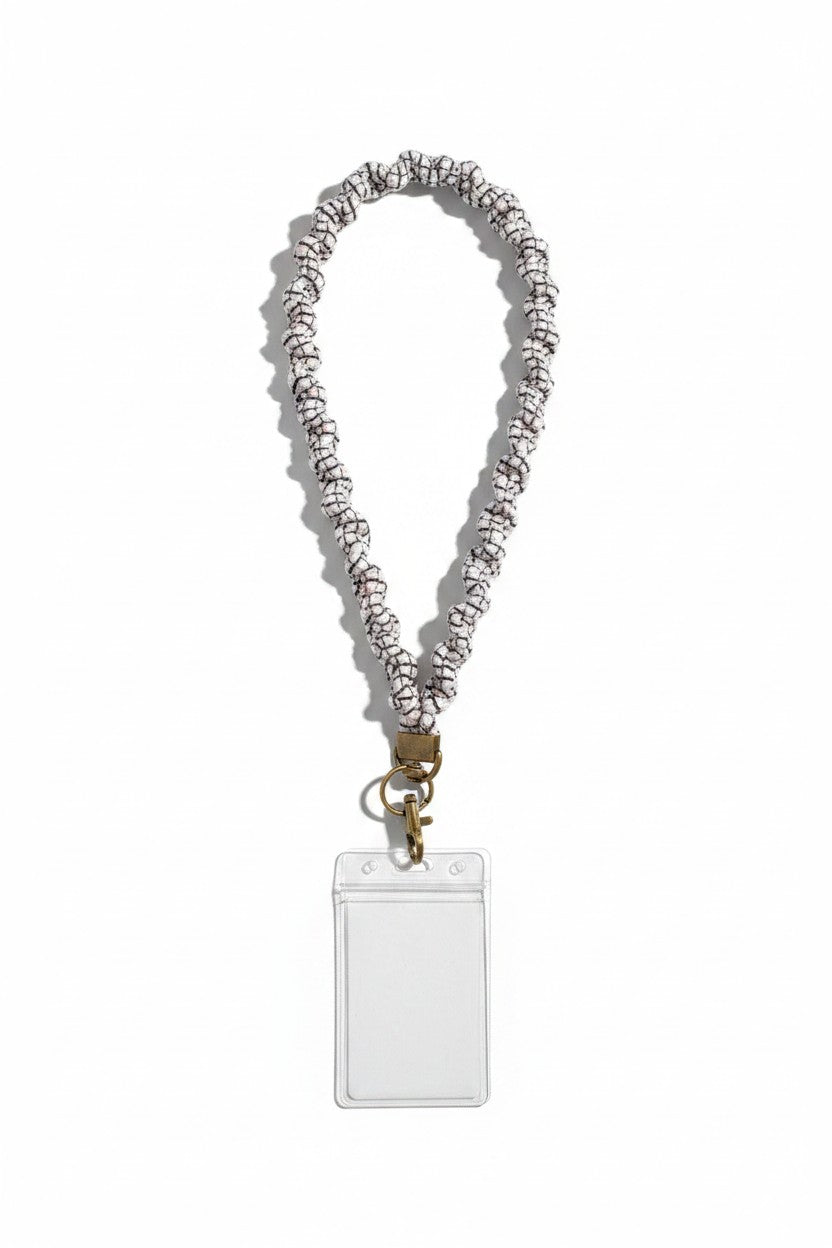 Doodlations Coffee Bar & Boutique black and white grid pattern polyester lanyard with a clear plastic ID badge holder.