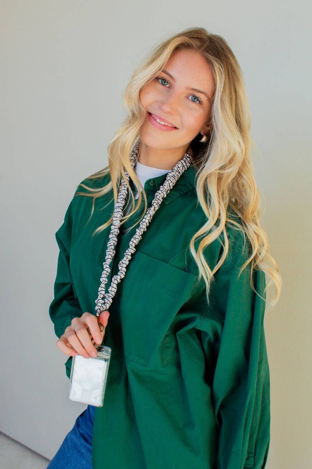 Doodlations Coffee Bar & Boutique black and white grid patterned crushed polyester lanyard worn by a blonde woman