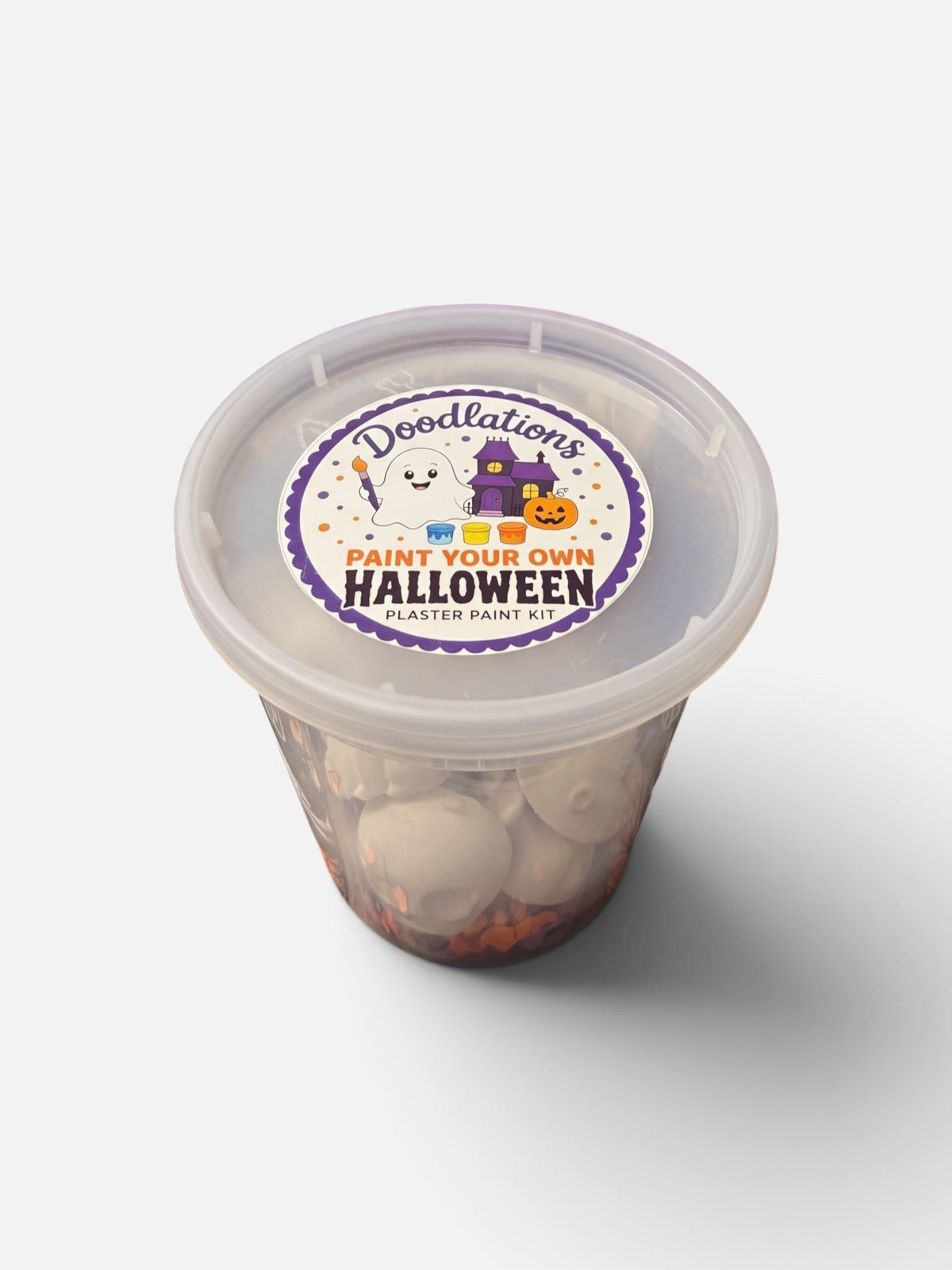 Doodlations Coffee Bar & Boutique Halloween plaster paint kit in a clear plastic container with a themed label.