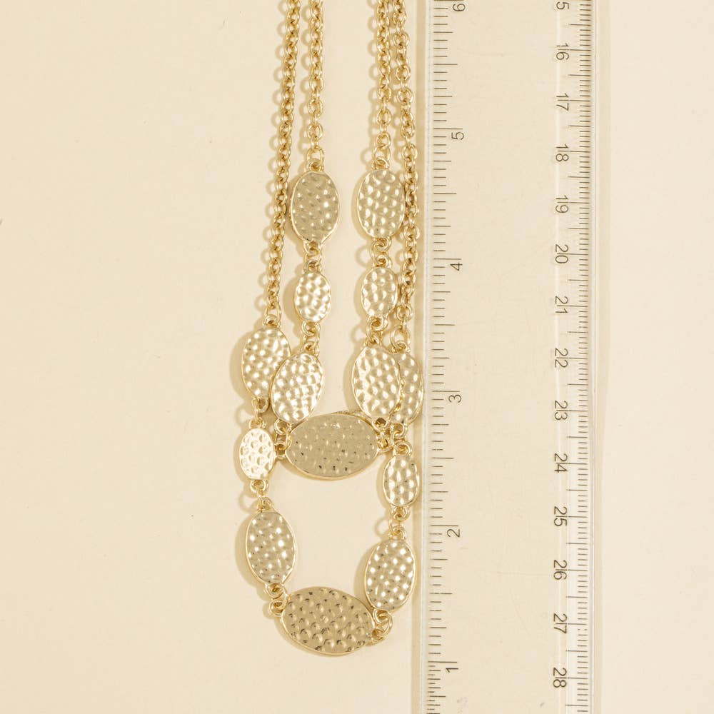 Doodlations Coffee Bar & Boutique gold-tone layered necklace with hammered oval stations and a measuring ruler.