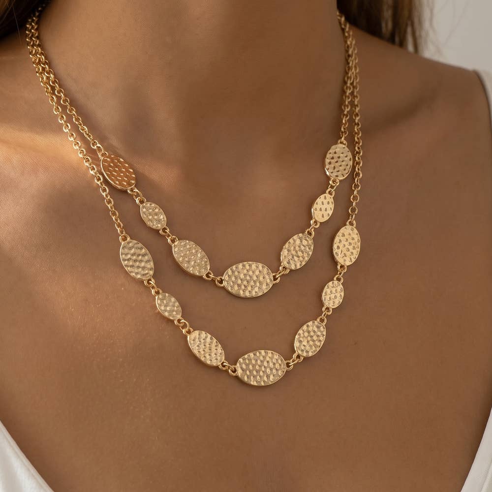 Doodlations Coffee Bar & Boutique gold-tone layered necklace with hammered oval stations on a delicate double chain.