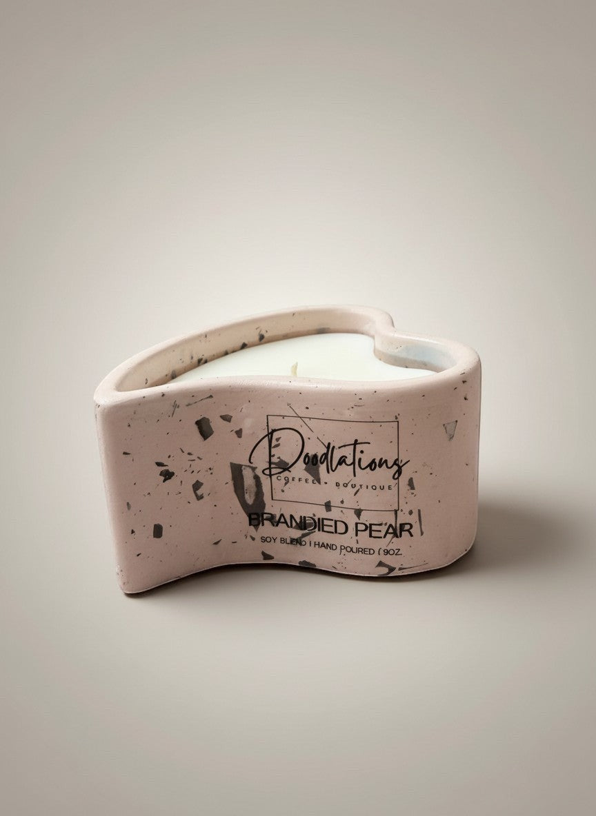 Doodlations Coffee Bar & Boutique pink concrete heart candle with black flecks, "Brandied Pear" scent.