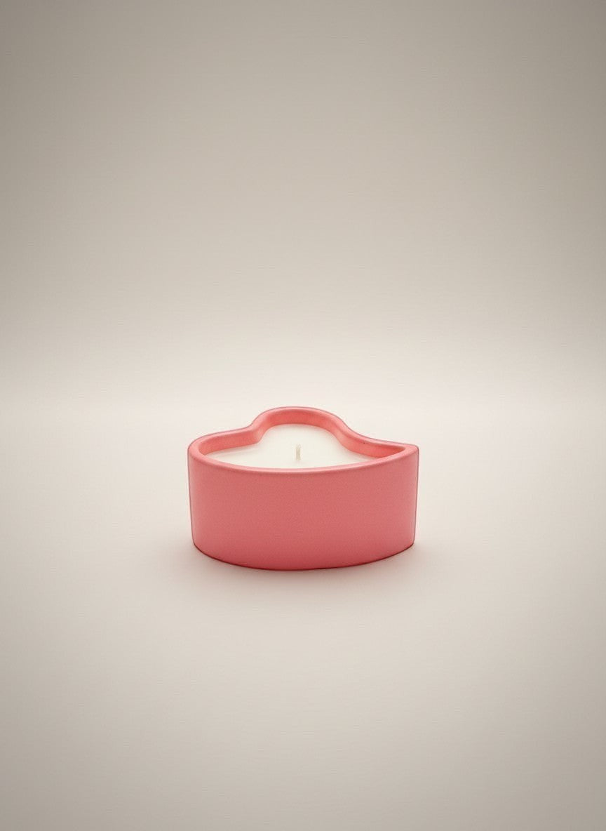 Doodlations Coffee Bar & Boutique coral pink heart-shaped concrete candle with white wax.