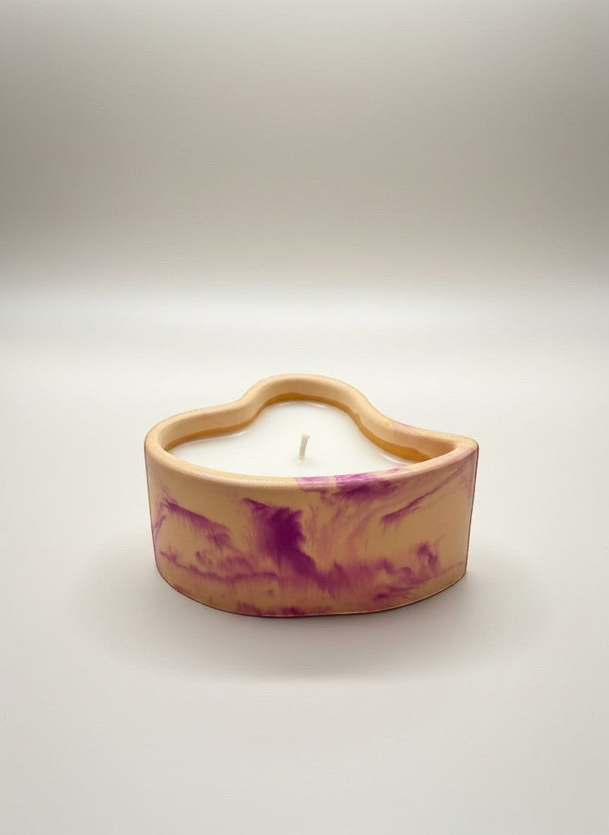 Doodlations Coffee Bar & Boutique heart-shaped concrete candle with white wax and purple marbling.