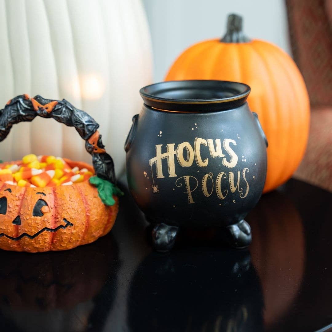 Doodlations Coffee Bar & Boutique matte black ceramic cauldron wax warmer with gold Hocus Pocus lettering and spider