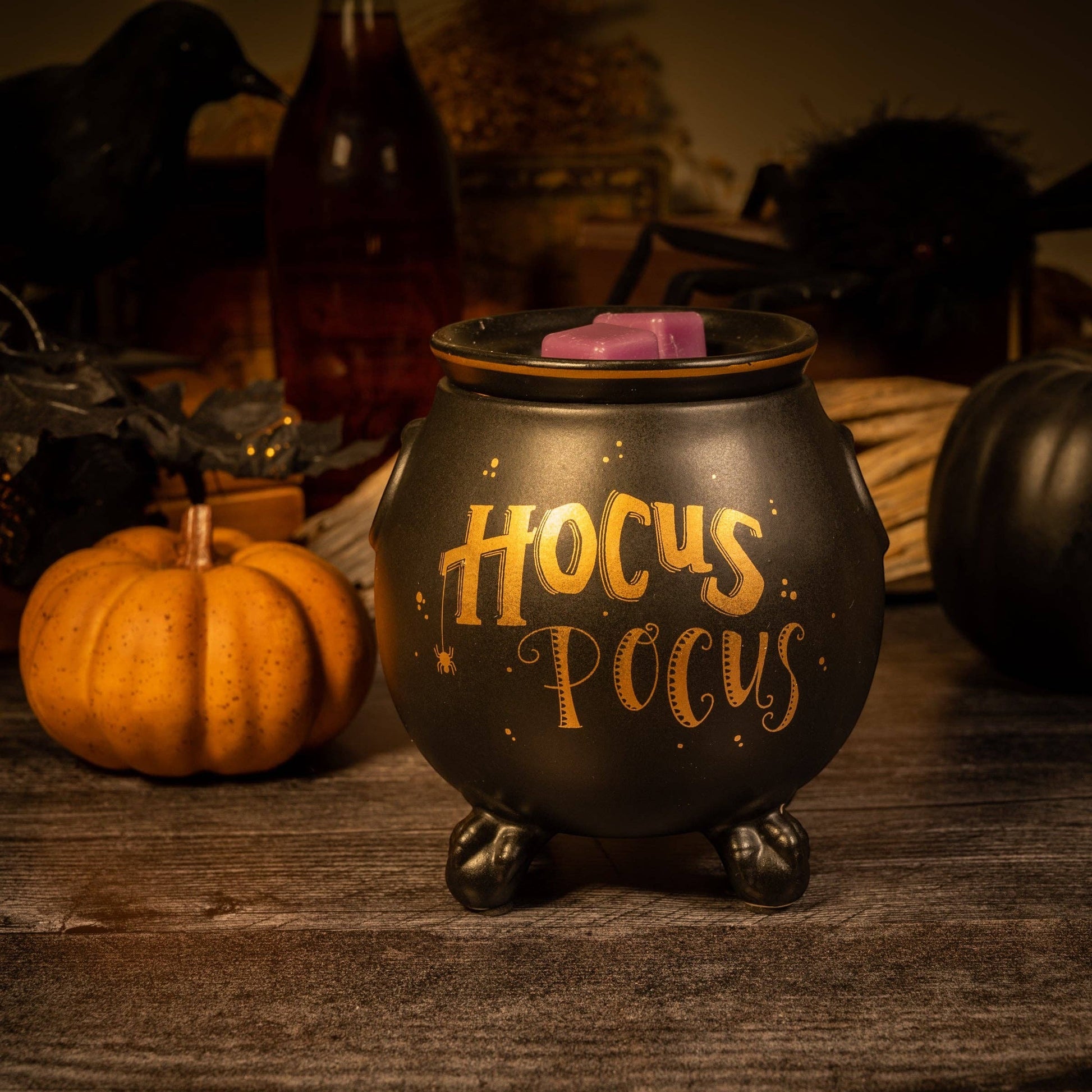 Doodlations Coffee Bar & Boutique matte black ceramic cauldron wax warmer with gold Hocus Pocus lettering and spider