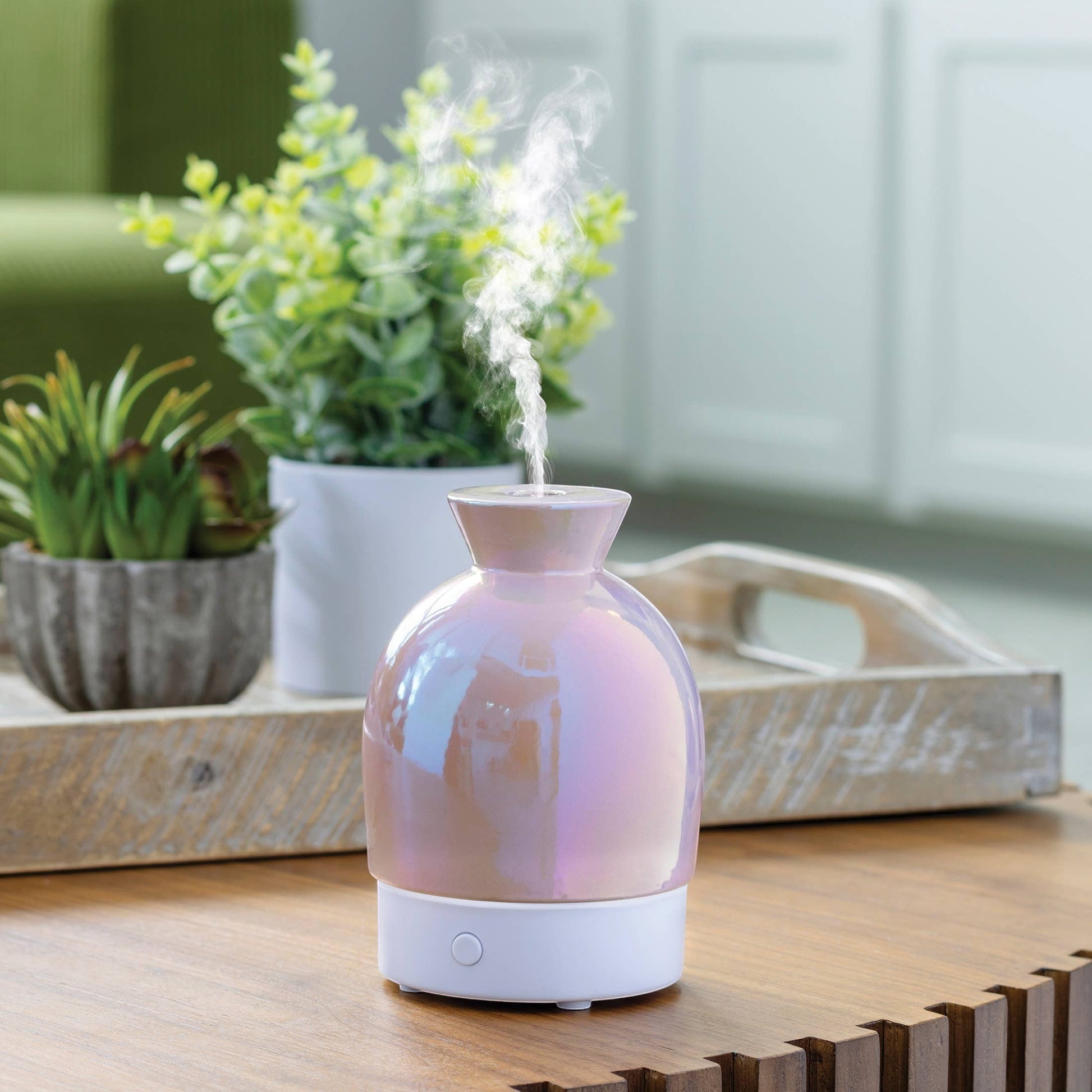 Doodlations iridescent water droplet aroma diffuser with pearlescent finish, emitting steam.