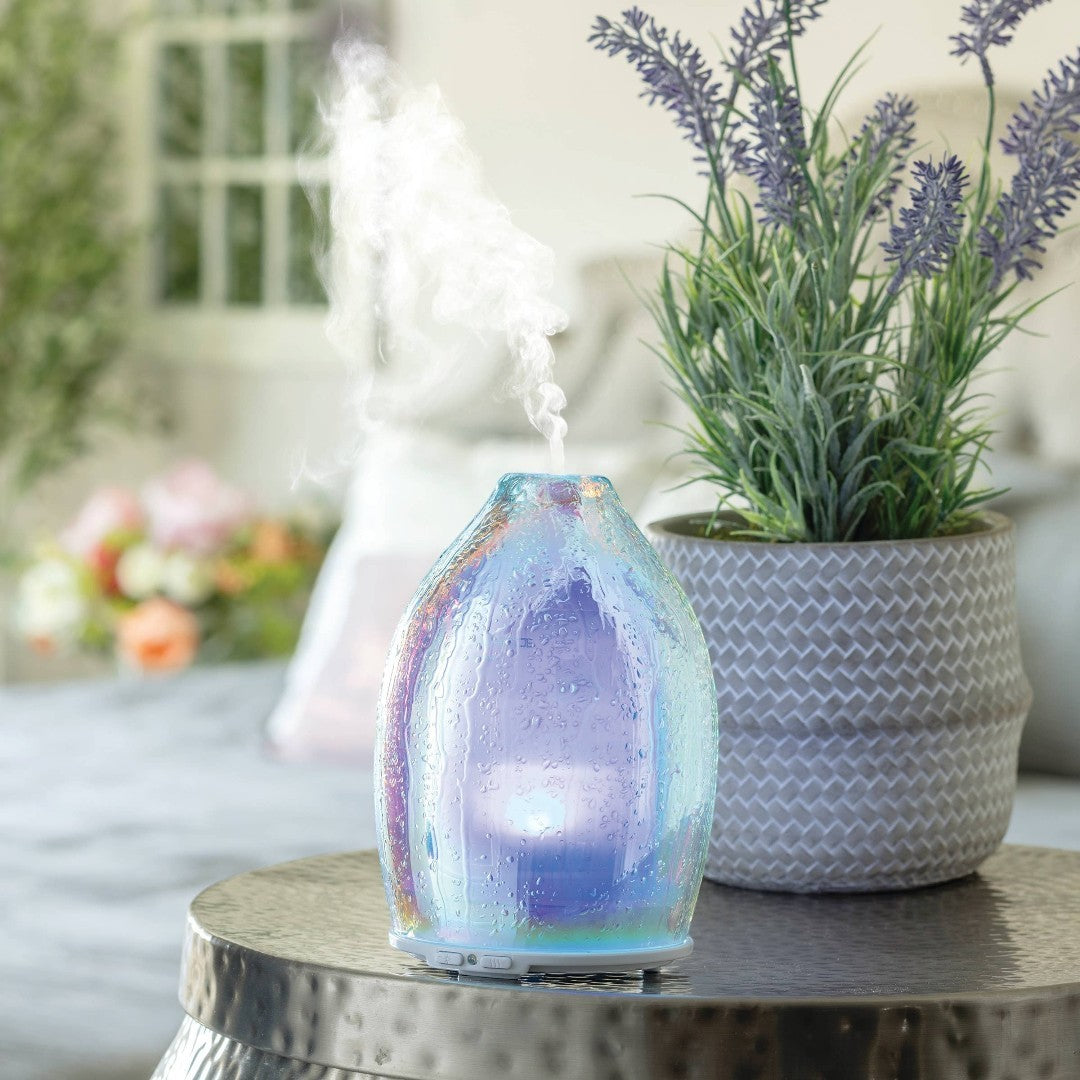 Doodlations Coffee Bar & Boutique iridescent water droplet glass aroma diffuser emitting mist.