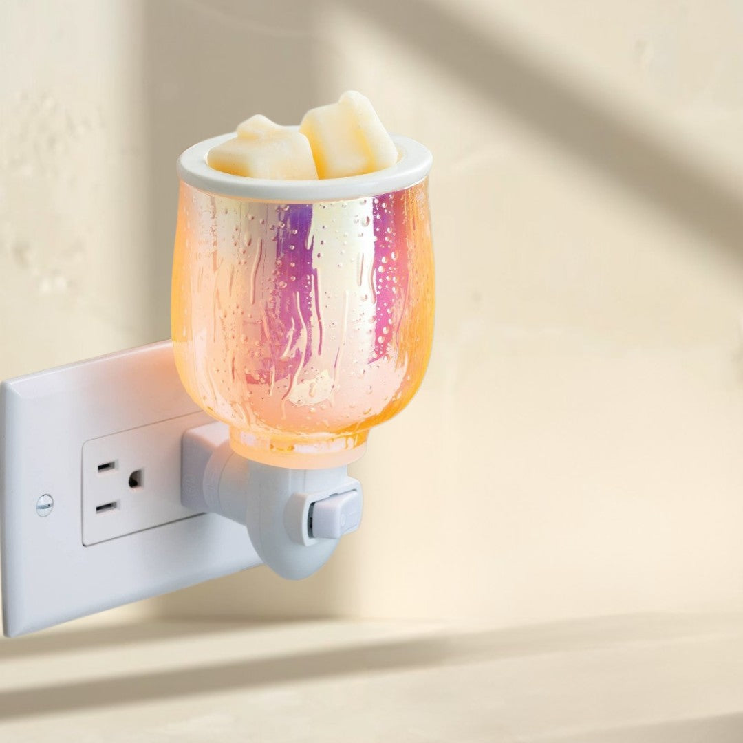 Doodlations Coffee Bar & Boutique iridescent plug-in wax warmer with a textured glass finish, melting wax cubes.